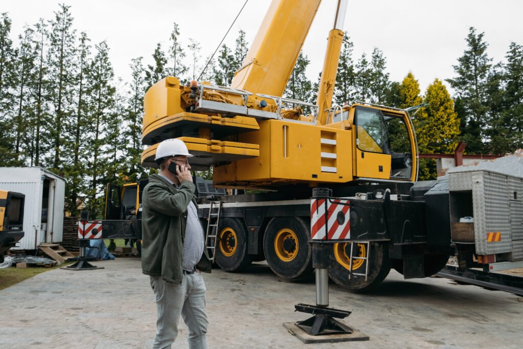 Foreman or architect on construction site talking by mobile phone